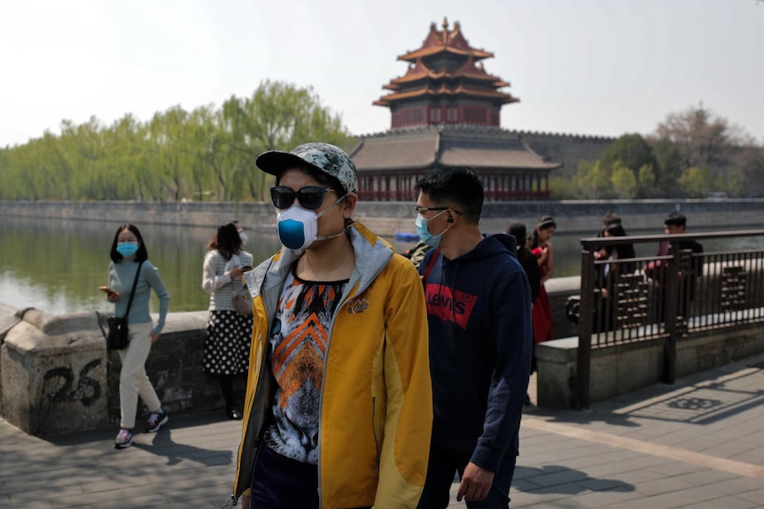 Tourists wearing protective face masks at the Forbidden City in Beijing.