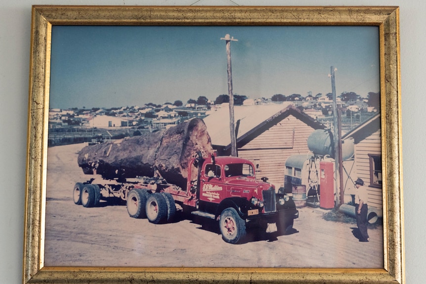 A photo frame of an old photo of a logging truck