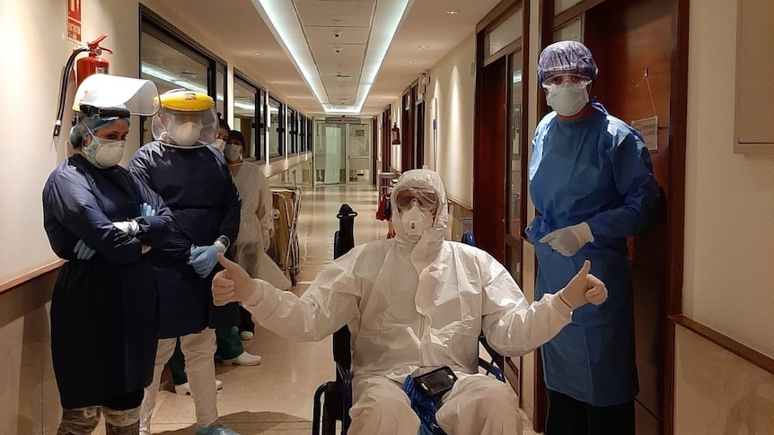 Jesz Fleming in full protective gear, surrounded by doctors in hospital
