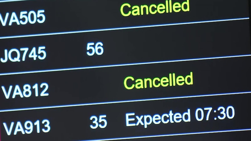 An airport sign displaying information about cancelled flights.