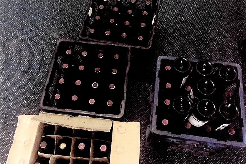 Bottles in boxes, on the floor.