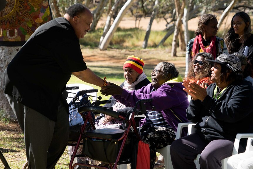 Martin Luther King III shakes the hand of an elder