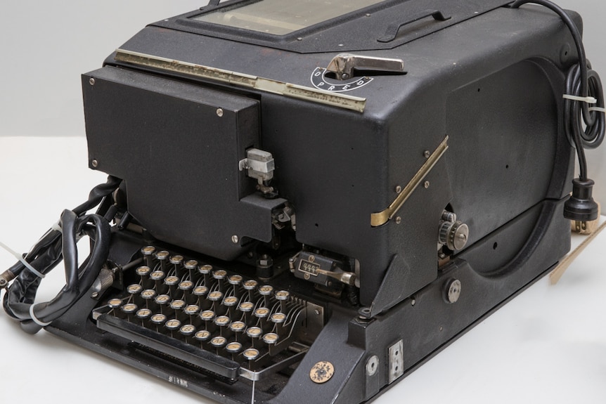 1940 electronic cypher machine sits on a white table.