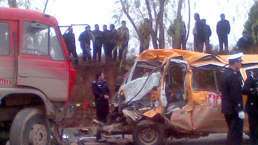 Police stand next to the school bus after the head-on collision.