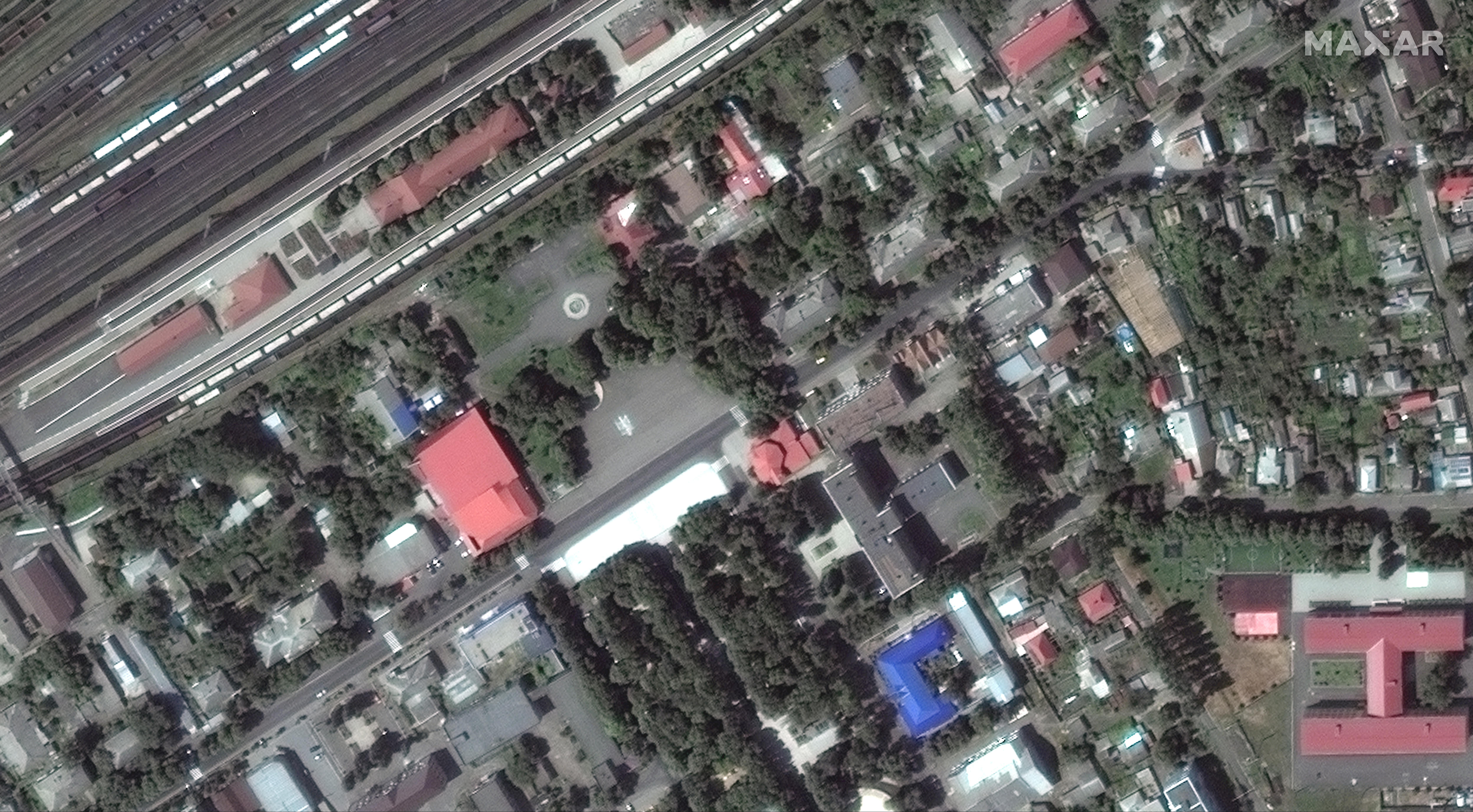 Satellite image of a train station and surrounding buildings in a city centre.