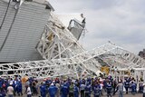 A crane killed two workers after it collapsed at a stadium set to host next year's World Cup opener.