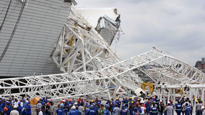 A crane killed two workers after it collapsed at a stadium set to host next year's World Cup opener.