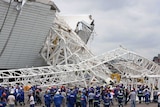 A crane killed two workers after it collapsed at a stadium set to host next year's World Cup opener.