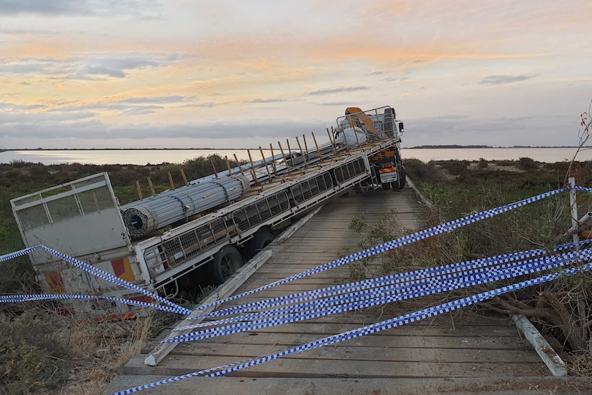 A truck and its trailer parked on a bridge near Adelaide's salt plains