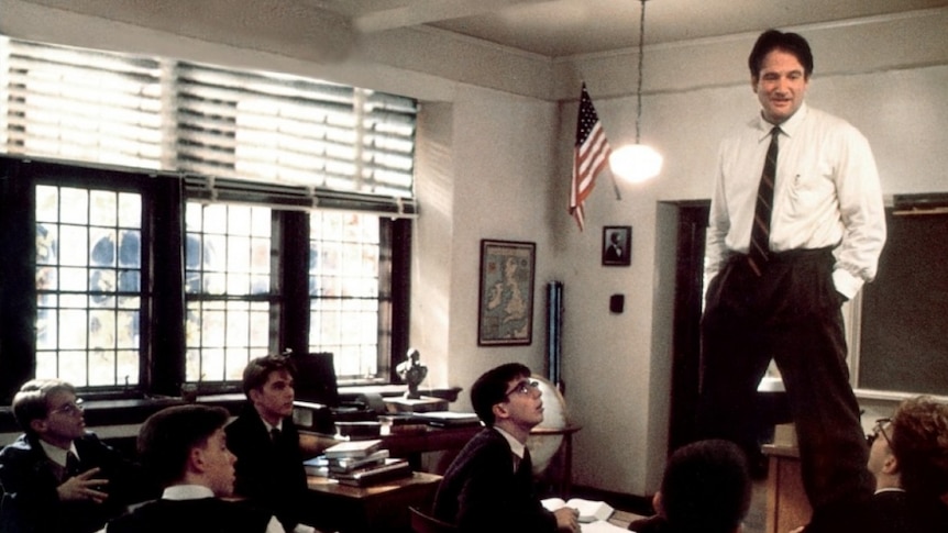 Robin Williams stands on desks in Dead Poets Society