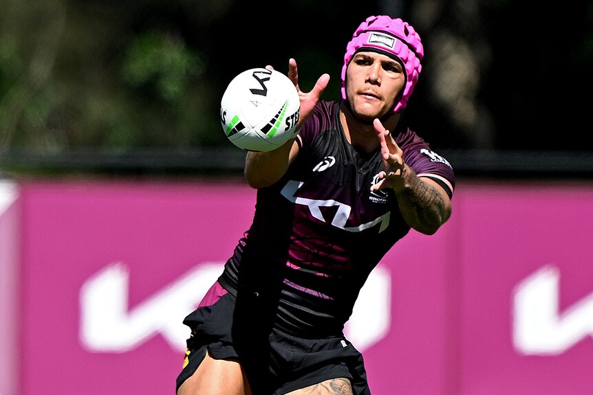 Reece Walsh catches a ball during a training session