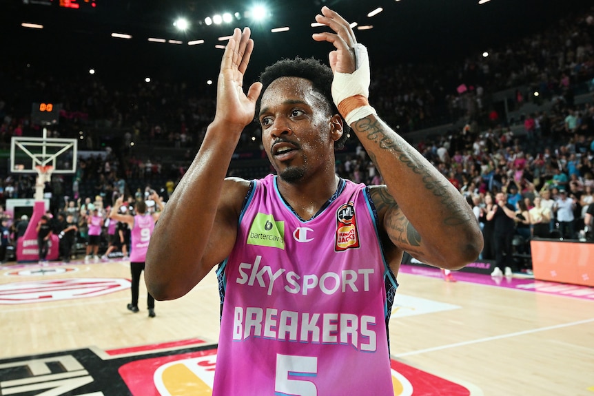 A New Zealand Breakers NBL player claps his hands after his side defeated the Sydney Kings.