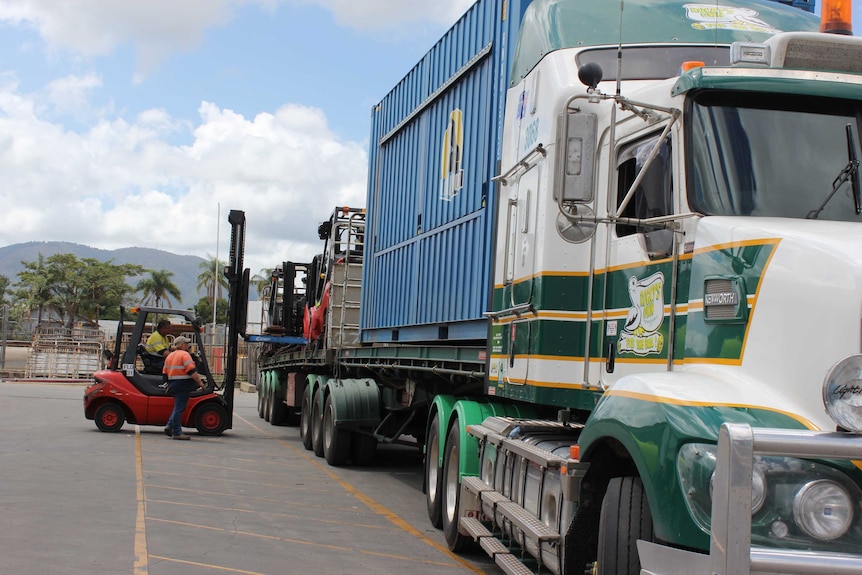 Semi trailer being loaded by forklift