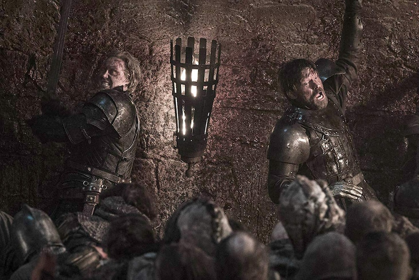 Brienne and Jaime pressed up against a wall fighting the undead.