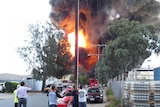 Locals watch the huge flames