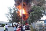 Locals watch the huge flames
