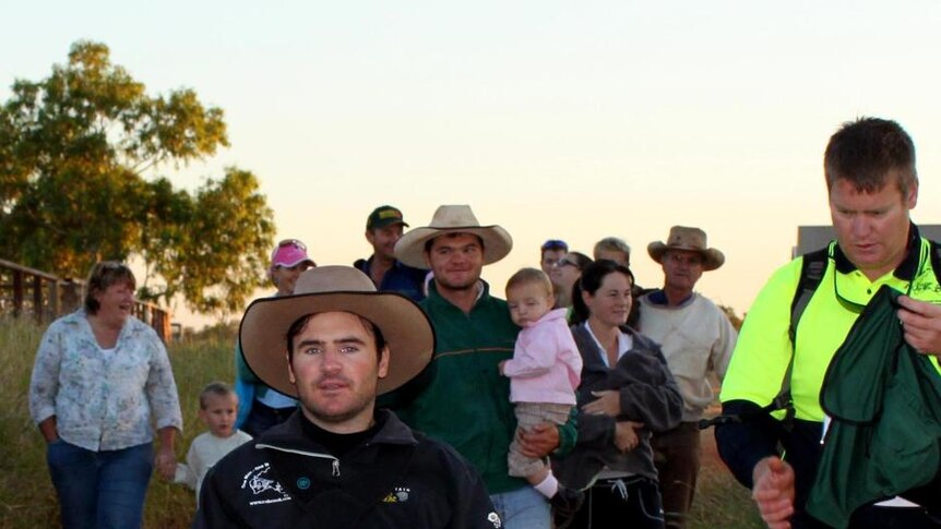 Friends surround Rob Cook as he leaves Suplejack station for his bid to become the first person to cross the remote Tanami Desert in a wheelchair.