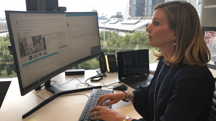 Australian eSafety Commissioner Julie Inman Grant types at a computer.