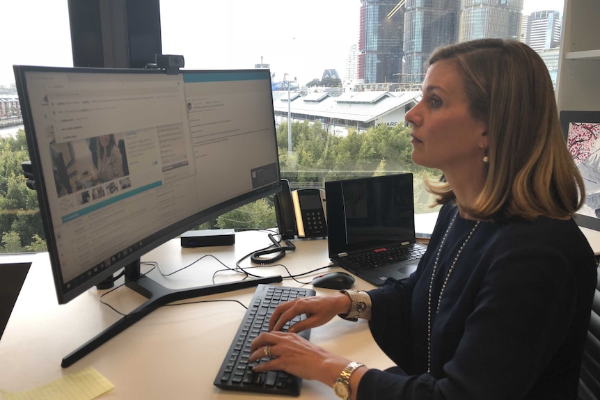 Australian eSafety Commissioner Julie Inman Grant types at a computer.