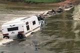Car and caravan get stuck at Cahill's Crossing in Kakadu National Park