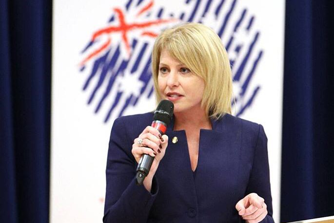 Rachel Carling-Jenkins stands at a podium in front of an Australian Conservatives banner.