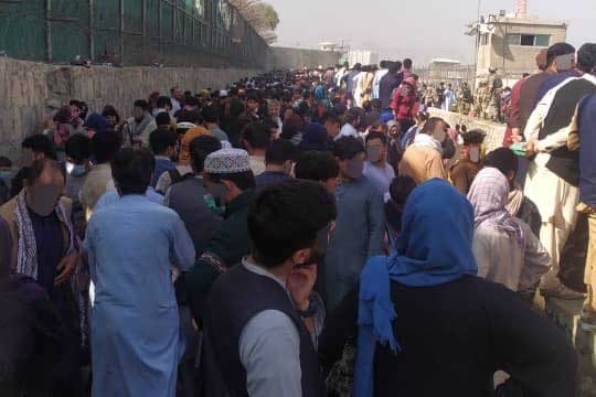 Ex-guards and families waiting outside Kabul airport in Afghanistan