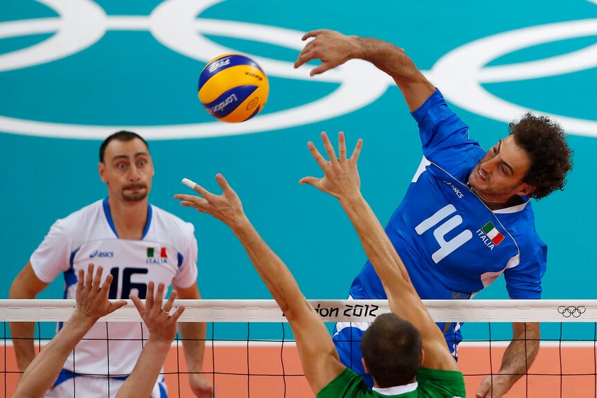 Alessandro Fei spikes the ball home for Italy in the bronze medal volleyball match.