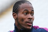 Jofra Archer readies to throw a cricket ball during an England training session