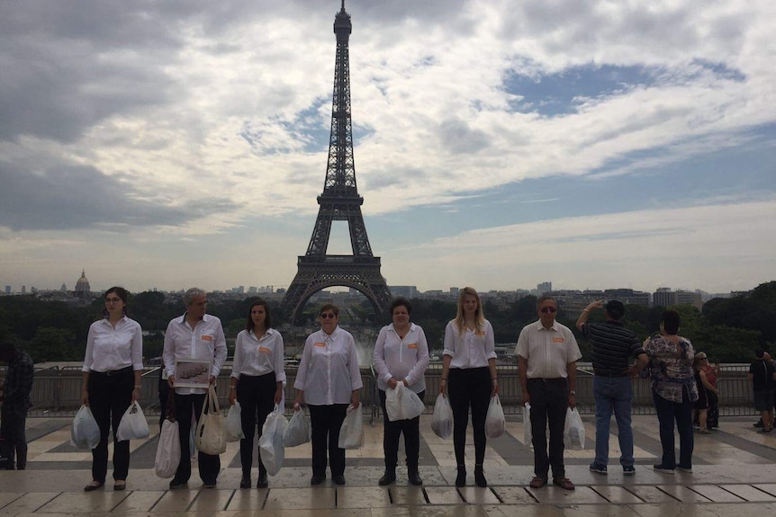 A group of activists protesting in the front of Eiffel Tower.l