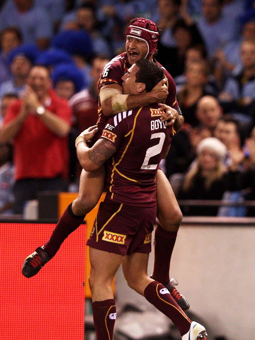 Darius Boyd (right) and Johnathan Thurston of the Maroons celebrate a try during this year's game one of State of Origin in Melbourne.