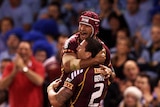 Darius Boyd and Johnathan Thurston of the Maroons celebrate a try