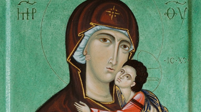 An image of an icon showing the Virgin Mary holding baby Jesus on a green background.