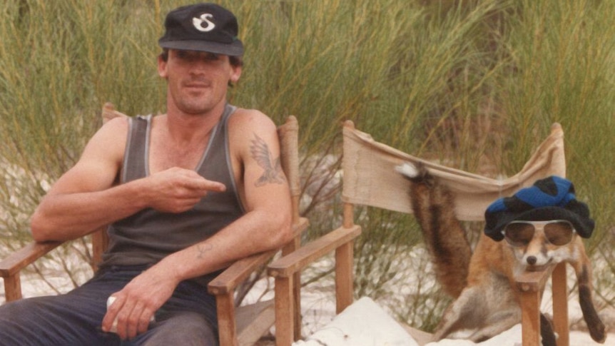 Murray sitting in a camp chair, with his friend the fox.