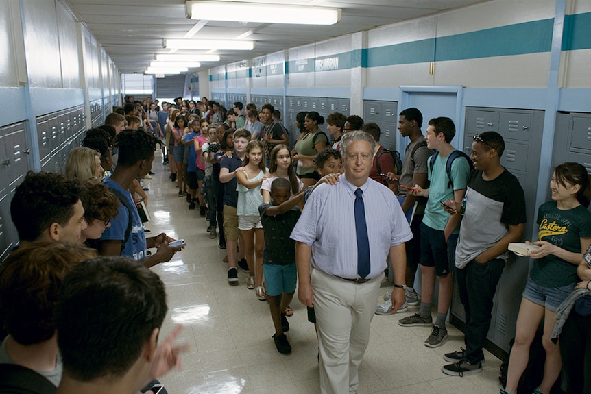 Colour still of a line of students in school hallway in 2018 film Eighth Grade.