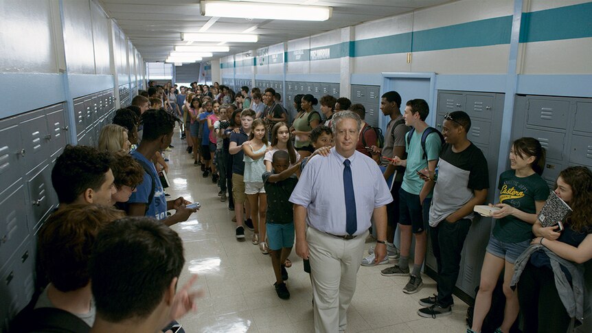 Colour still of a line of students in school hallway in 2018 film Eighth Grade.