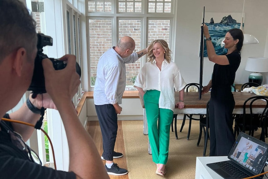 Camera crew filming Sales in a dining room.