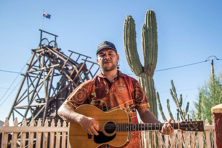 Burt Hayden standing in front of the historic Gwalia timber mining headframe.