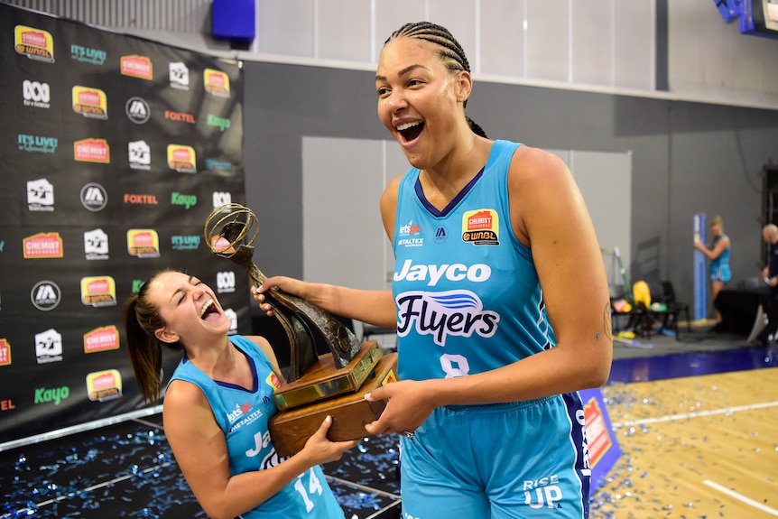 Monique Conti and Liz Cambage celebrate winning the WNBL title in 2020.