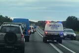 Police wagon travelling through heavy traffic