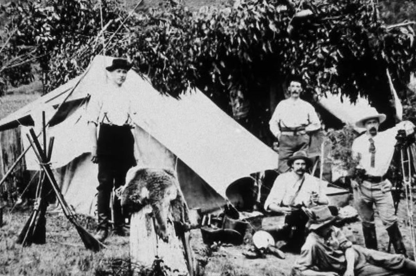 1927 photo of koala hunters at a campsite.