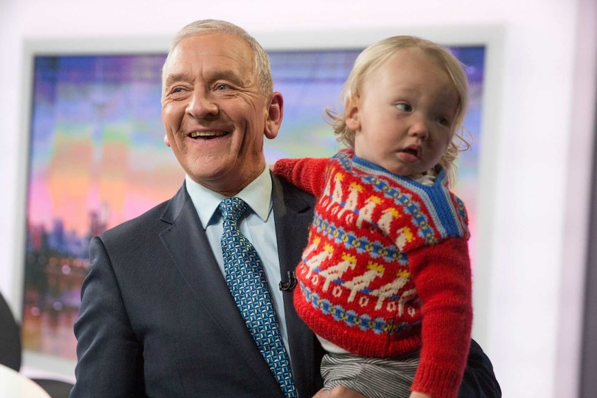 Ian Henderson holds his grandson.