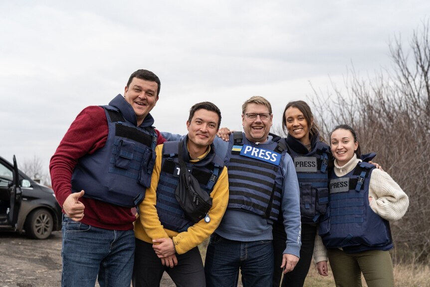 ABC journalists Tom Joyner and Isabella Higgins in Ukraine with fixers and producers in 2023