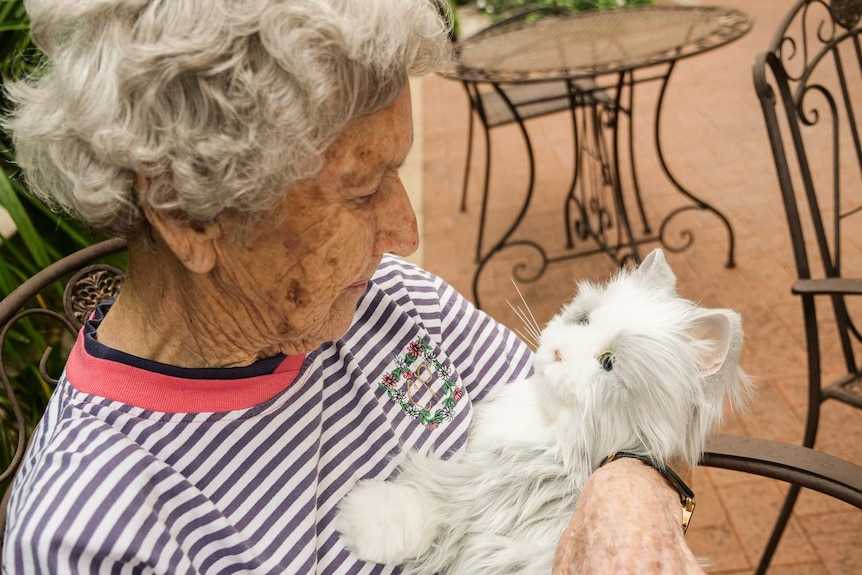 Close up of aged care resident Valerie with a robotic cat