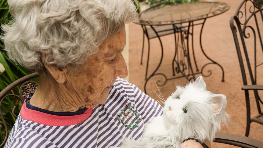 Close up of aged care resident Valerie with a robotic cat