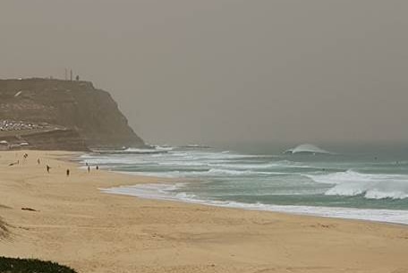 a beach shrouded in a dust storm