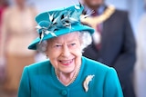 Queen Elizabeth smiles in a green dress and hat this file photo from July.