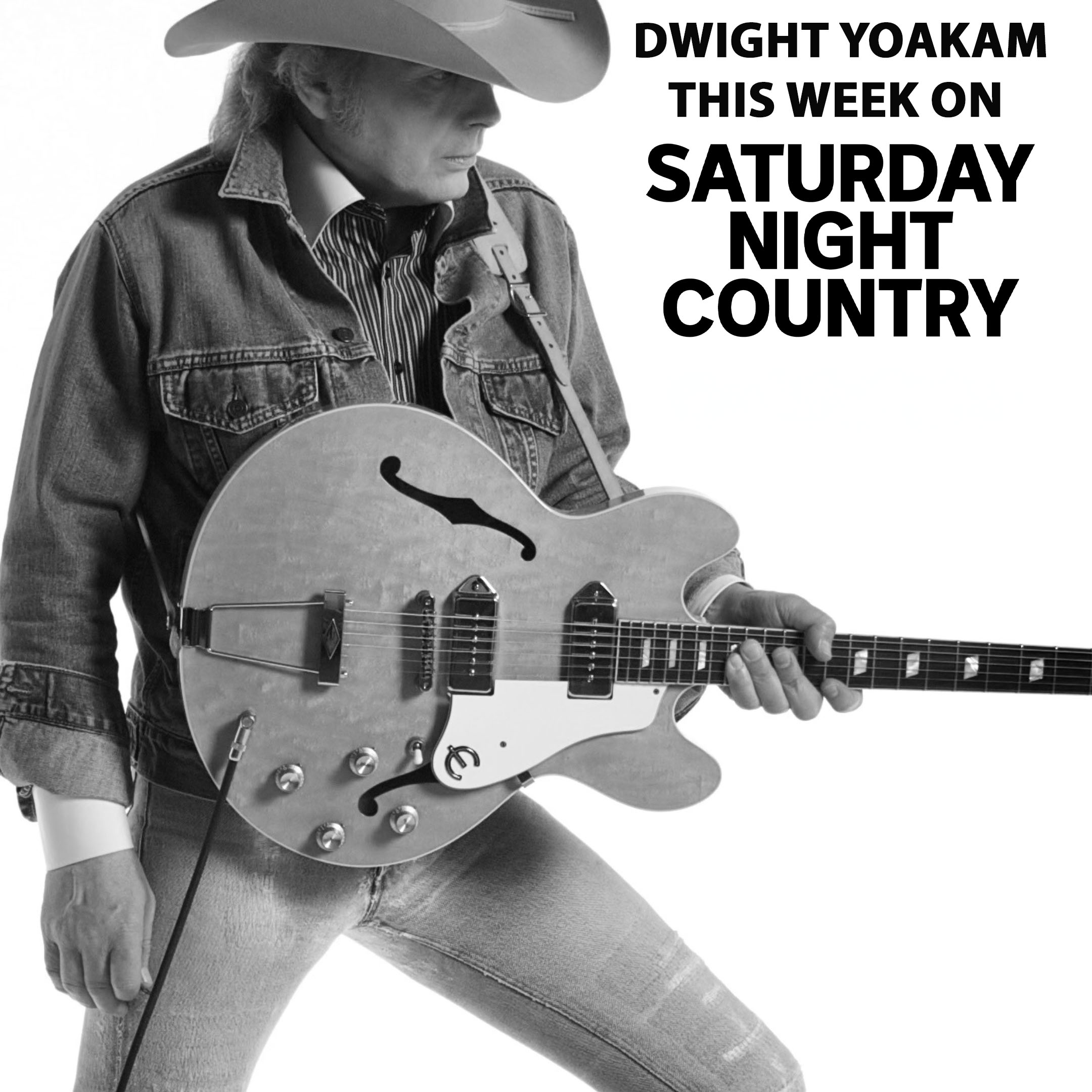 Country music star Dwight Yoakam stnading up with a cowboy hat and an Epiphone guitar