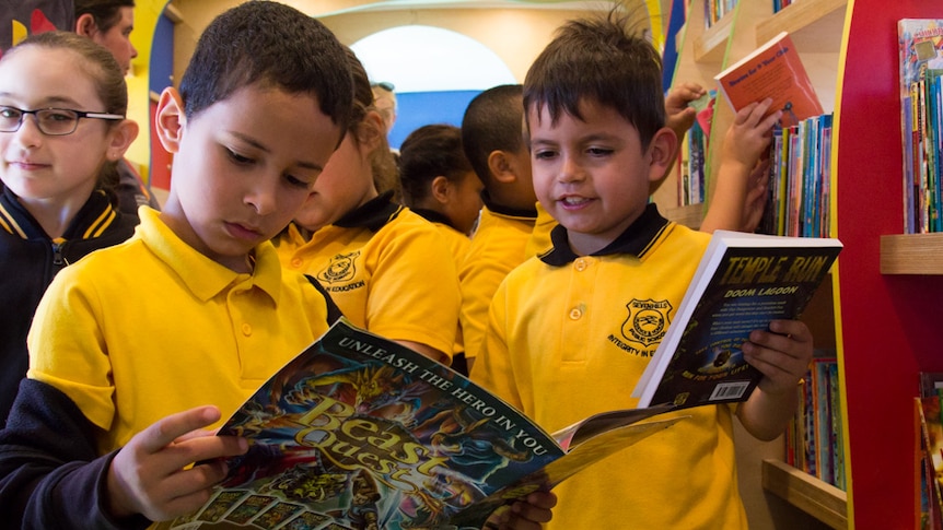 School students read in a library bus