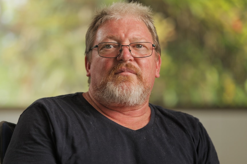 A man wearing a black shirt.