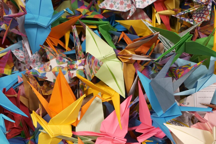 Thousands of colourful origami paper cranes 